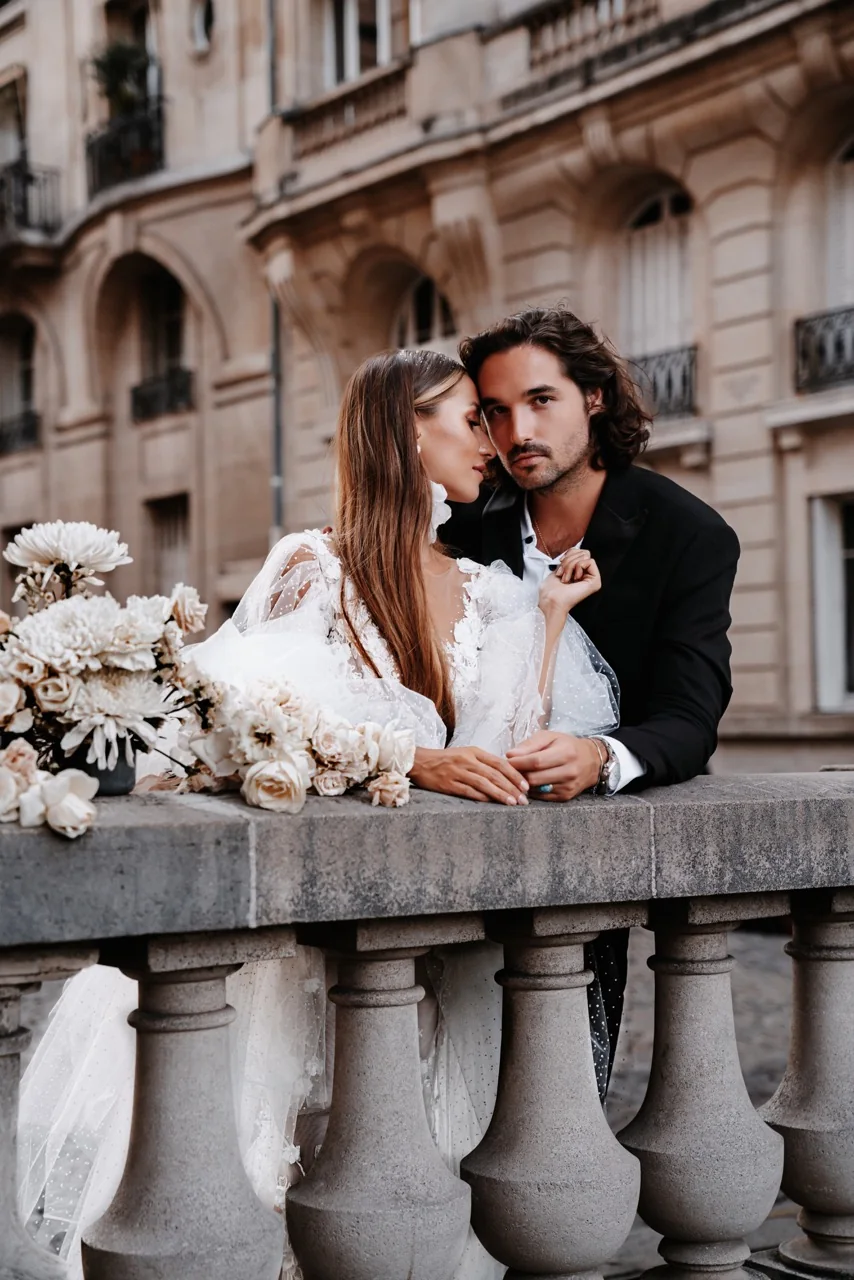 Anais and Antoine on a balustrade, pale flowers in the foreground