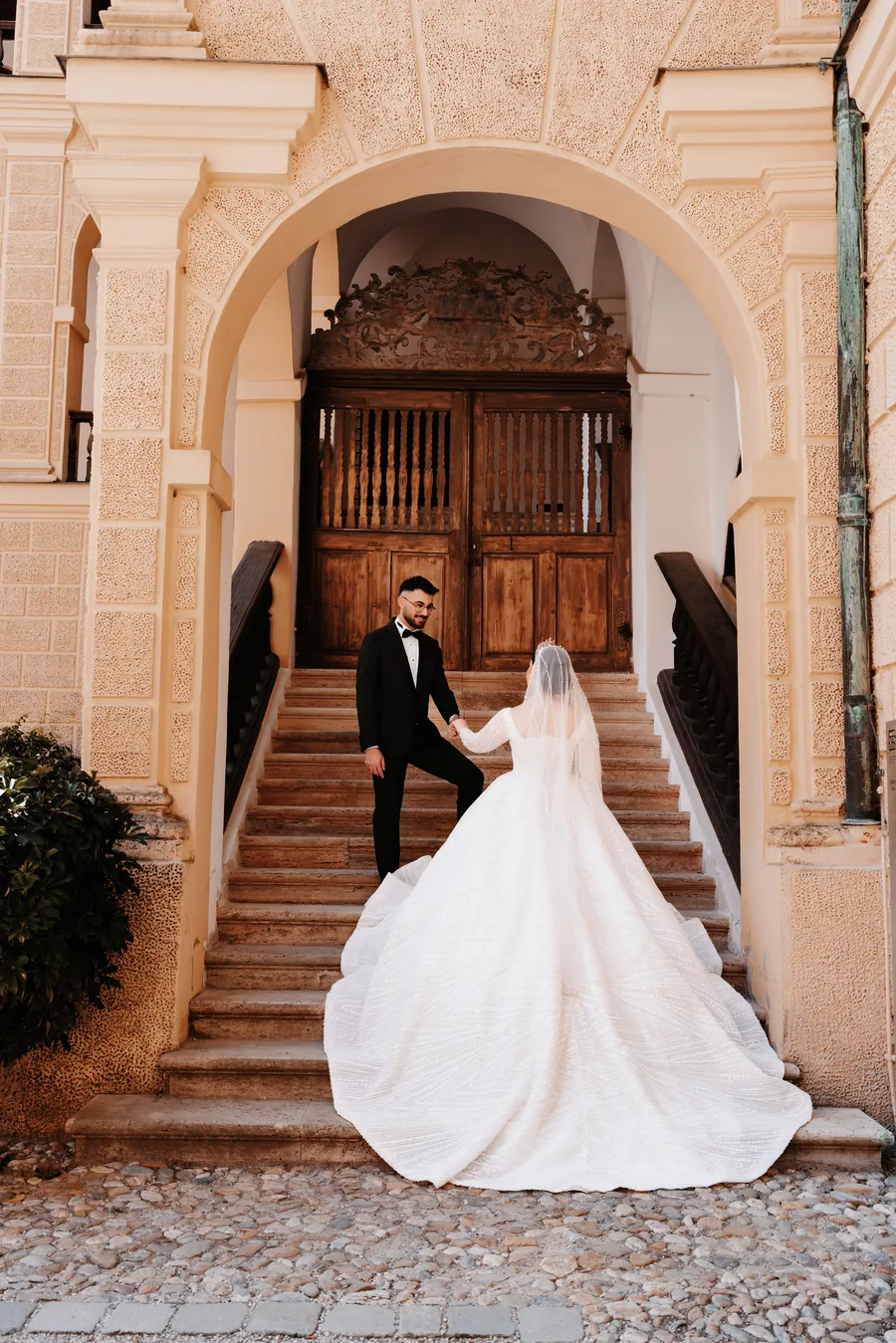 Berkay leading Bade up the steps, her dress filling the whole staircase